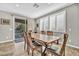 Dining room features large wood table and plantation shutters with backyard views through sliding glass door at 12932 W Cassia Trl, Peoria, AZ 85383