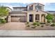Two-story home featuring desert landscaping, tile roof, solar panels, and a two-car garage at 12932 W Cassia Trl, Peoria, AZ 85383