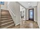 Inviting foyer with tiled floors, a decorative front door, and staircase to the upper level at 12932 W Cassia Trl, Peoria, AZ 85383