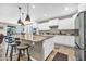 Open-concept kitchen features a large center island with seating and modern pendant lighting at 12932 W Cassia Trl, Peoria, AZ 85383