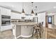 Kitchen featuring white cabinetry, stainless appliances and an oversized kitchen island at 12932 W Cassia Trl, Peoria, AZ 85383