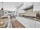 Gourmet kitchen featuring white cabinets, granite counters, and stainless steel appliances at 12932 W Cassia Trl, Peoria, AZ 85383