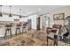 Open-concept living space with tiled floors, breakfast bar and view of stairs at 12932 W Cassia Trl, Peoria, AZ 85383