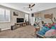 Versatile living room featuring a large television, ceiling fan, and plenty of space for activities and relaxation at 12932 W Cassia Trl, Peoria, AZ 85383