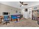 Spacious living room with a ceiling fan, comfortable seating, and a view of the bathroom at 12932 W Cassia Trl, Peoria, AZ 85383