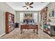 Bright and well-organized home office with two monitors, a bookshelf, and natural light at 12932 W Cassia Trl, Peoria, AZ 85383