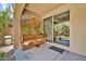 View of patio with wooden planters, trellis, and sliding glass door to home interior at 12932 W Cassia Trl, Peoria, AZ 85383