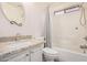 This bathroom features a tub and shower combo, a granite vanity and updated fixtures at 13216 W Desert Ln, Surprise, AZ 85374