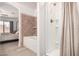 Ensuite bathroom with shower, soaking tub, and tile accents is accessed through the primary bedroom at 13216 W Desert Ln, Surprise, AZ 85374