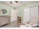 Bedroom is equipped with wood-look tile flooring, a changing table, and plenty of room to relax at 13216 W Desert Ln, Surprise, AZ 85374