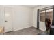 This bedroom features gray wood-look floors and a window with natural light at 13216 W Desert Ln, Surprise, AZ 85374