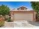 Charming single-Gathering home featuring a two-car garage, desert landscaping, and a tile roof at 13216 W Desert Ln, Surprise, AZ 85374