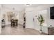 Inviting entryway featuring wood-look flooring, a dining table, and a decorative plant at 13216 W Desert Ln, Surprise, AZ 85374