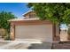 The property includes a clean two-car garage, with a concrete driveway, and easy street access at 13216 W Desert Ln, Surprise, AZ 85374