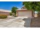 The property includes a clean two-car garage, with a concrete driveway, and easy street access at 13216 W Desert Ln, Surprise, AZ 85374