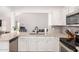 Bright kitchen boasts granite counters, gray subway tile backsplash, and modern stainless steel appliances at 13216 W Desert Ln, Surprise, AZ 85374