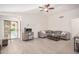 Bright living room with tile flooring, comfortable seating, and access to the backyard pool at 13216 W Desert Ln, Surprise, AZ 85374