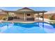 The backyard includes a refreshing pool and covered patio, great for relaxation and leisure at 13216 W Desert Ln, Surprise, AZ 85374