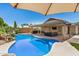 Inviting backyard oasis with a sparkling pool and covered patio, perfect for outdoor entertaining at 13216 W Desert Ln, Surprise, AZ 85374