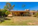 Spacious backyard featuring a covered patio, lush landscaping, and ample space for outdoor activities at 1326 W Joan De Arc Ave, Phoenix, AZ 85029