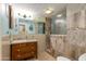 Stylishly renovated bathroom with glass enclosed shower, granite counters, and ample lighting at 1326 W Joan De Arc Ave, Phoenix, AZ 85029