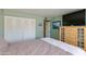 Bright bedroom featuring ample closet space, wood dresser, and relaxing green walls at 1326 W Joan De Arc Ave, Phoenix, AZ 85029