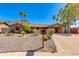 Charming stone facade home with desert landscaping, mature trees and an attached carport at 1326 W Joan De Arc Ave, Phoenix, AZ 85029