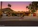 Charming stone home with lush landscaping and a covered carport provides curb appeal and convenience at 1326 W Joan De Arc Ave, Phoenix, AZ 85029