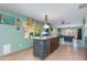 Open-concept kitchen features a large island with seating, tiled accents, and view of the game room at 1326 W Joan De Arc Ave, Phoenix, AZ 85029
