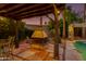 Outdoor fire pit with seating creating an inviting space for relaxing and entertaining by the pool at 1326 W Joan De Arc Ave, Phoenix, AZ 85029