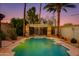 Inviting pool and waterfall surrounded by lush greenery offering a private outdoor oasis at 1326 W Joan De Arc Ave, Phoenix, AZ 85029