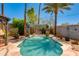 Inviting backyard pool with decorative waterfall and lush greenery, ideal for relaxation at 1326 W Joan De Arc Ave, Phoenix, AZ 85029