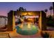 Backyard pool with decorative waterfall and lush tropical landscaping creating a relaxing retreat at 1326 W Joan De Arc Ave, Phoenix, AZ 85029