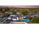 Aerial view of the property with a lush backyard oasis featuring a pool, patio, and outdoor dining area at 14012 N 57Th Pl, Scottsdale, AZ 85254