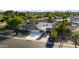 Aerial view showcases updated home with a covered carport, pristine driveway, mature trees, and manicured landscaping at 14012 N 57Th Pl, Scottsdale, AZ 85254