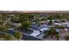 Magnificent aerial view of the property at dusk with a stylish backyard and pool at 14012 N 57Th Pl, Scottsdale, AZ 85254