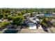 Aerial view of landscaped property showcasing the pool, carport, and pristine driveway, set in a verdant neighborhood at 14012 N 57Th Pl, Scottsdale, AZ 85254