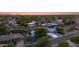 Serene aerial perspective of the home with a beautiful pool and landscaped yard at twilight at 14012 N 57Th Pl, Scottsdale, AZ 85254