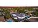 Aerial view of a home featuring a backyard oasis with a pool, lush landscaping, and covered parking at 14012 N 57Th Pl, Scottsdale, AZ 85254