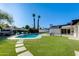 Spacious backyard with pool and landscaped area, great for outdoor entertaining and relaxation under the sun at 14012 N 57Th Pl, Scottsdale, AZ 85254