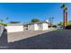 Expansive backyard features desert landscaping, a white-painted brick house, and a pool with a pristine blue color at 14012 N 57Th Pl, Scottsdale, AZ 85254