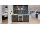 Chic bar area with wine fridge, custom backsplash, and open layout to the kitchen at 14012 N 57Th Pl, Scottsdale, AZ 85254