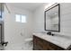 Stylish bathroom featuring marble countertop, dark wood vanity, and unique geometric floor tiles at 14012 N 57Th Pl, Scottsdale, AZ 85254