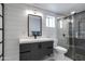 Modern bathroom with shiplap walls, a gray vanity, and a glass-enclosed shower with patterned tiles at 14012 N 57Th Pl, Scottsdale, AZ 85254