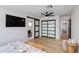Bright bedroom with a ceiling fan, barn door to en-suite bathroom, and frosted-glass closet doors at 14012 N 57Th Pl, Scottsdale, AZ 85254