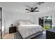 Tranquil bedroom featuring a plush bed, modern decor, a sliding glass door to the backyard and a ceiling fan at 14012 N 57Th Pl, Scottsdale, AZ 85254