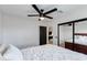 Bright bedroom with a ceiling fan, neutral tones, and a mirrored closet at 14012 N 57Th Pl, Scottsdale, AZ 85254