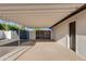 Attached carport provides covered parking with a painted aluminum covering and backyard access at 14012 N 57Th Pl, Scottsdale, AZ 85254