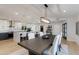 Bright dining room with stylish lighting, a large table, and a view into the open kitchen at 14012 N 57Th Pl, Scottsdale, AZ 85254