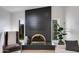 Modern fireplace with striking black surround, marble hearth, and decorative accents at 14012 N 57Th Pl, Scottsdale, AZ 85254
